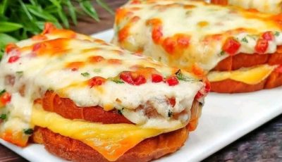 This looks like a cheesy baked toast sandwich with salami (or pepperoni), sliced cheese, and a creamy sauce.